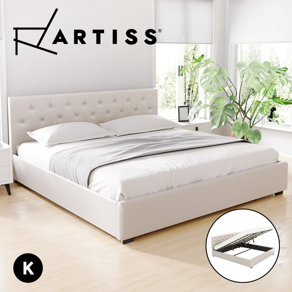 White bed with tufted headboard in a bright room with plants, featuring the Artiss brand.